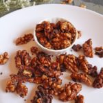 Crunchy air fryer candied walnuts with caramelized sugar, cinnamon, and honey.