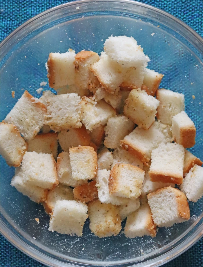 Bread cubes tossed with herbs and seasoning before air frying