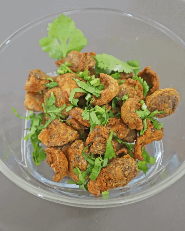 Raw cleaned chicken gizzards in a bowl ready to be seasoned