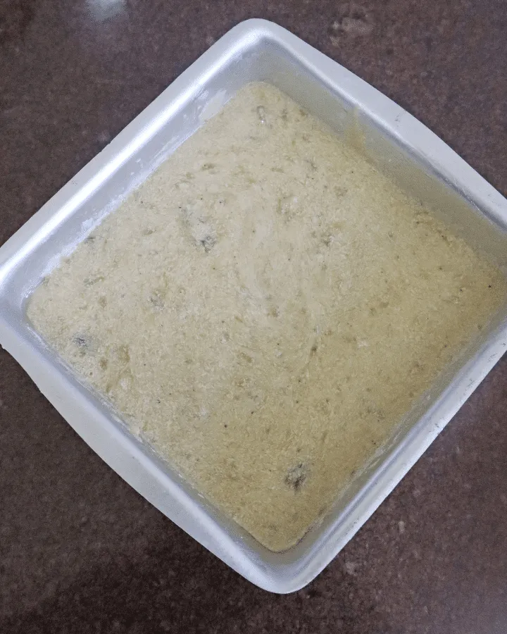 Banana bread batter in a dish placed in the air fryer basket