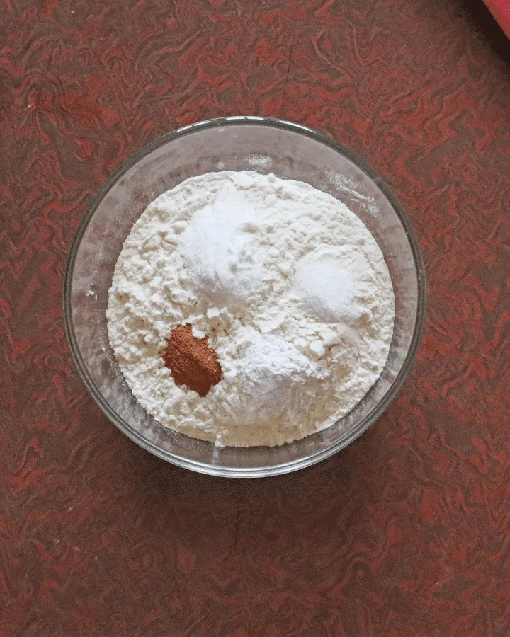Flour, cinnamon and baking spices whisked together in a mixing bowl