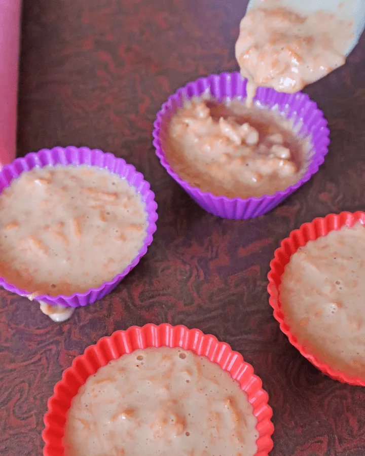 Muffin batter spooned into silicone baking cups