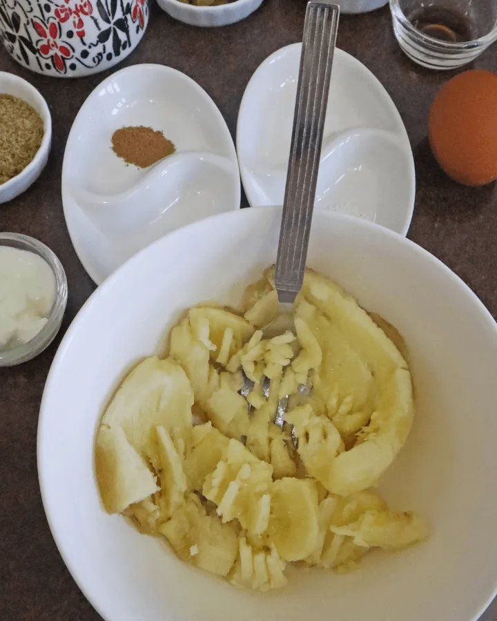 Ripe bananas mashed smooth in a bowl