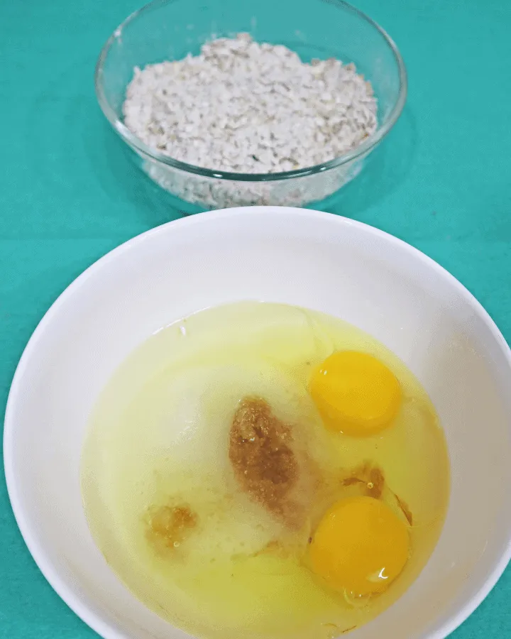 Eggs, oil, sugar and vanilla whisked together for oatmeal cookie dough