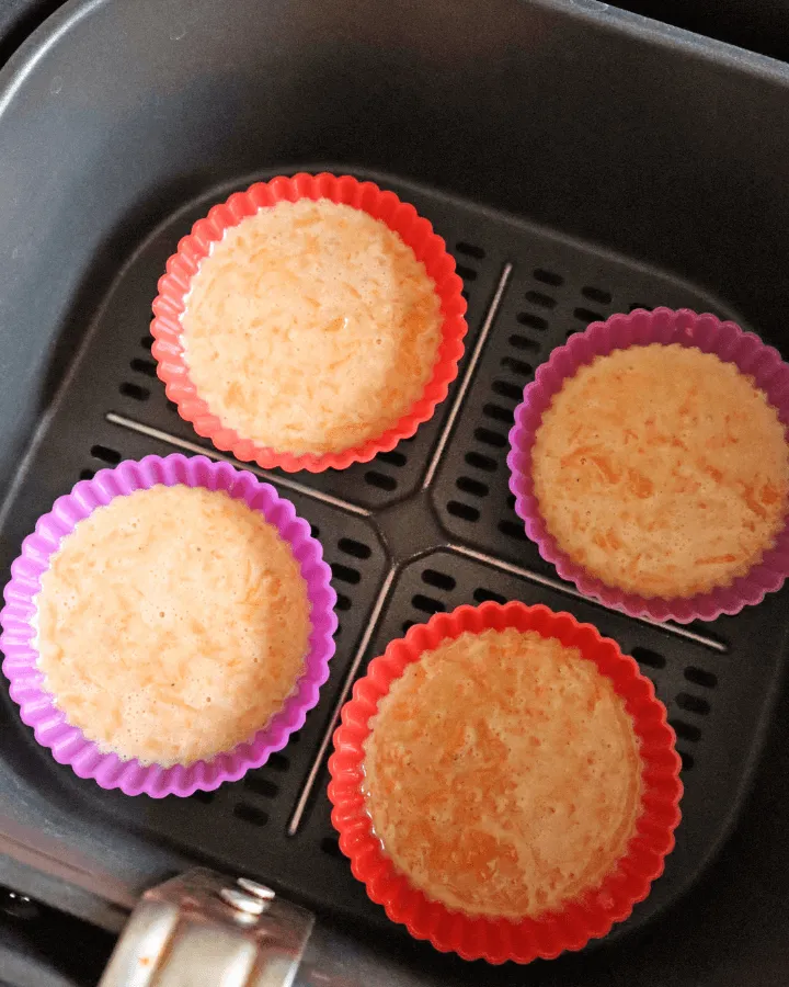 Filled muffin cups placed in the air fryer basket