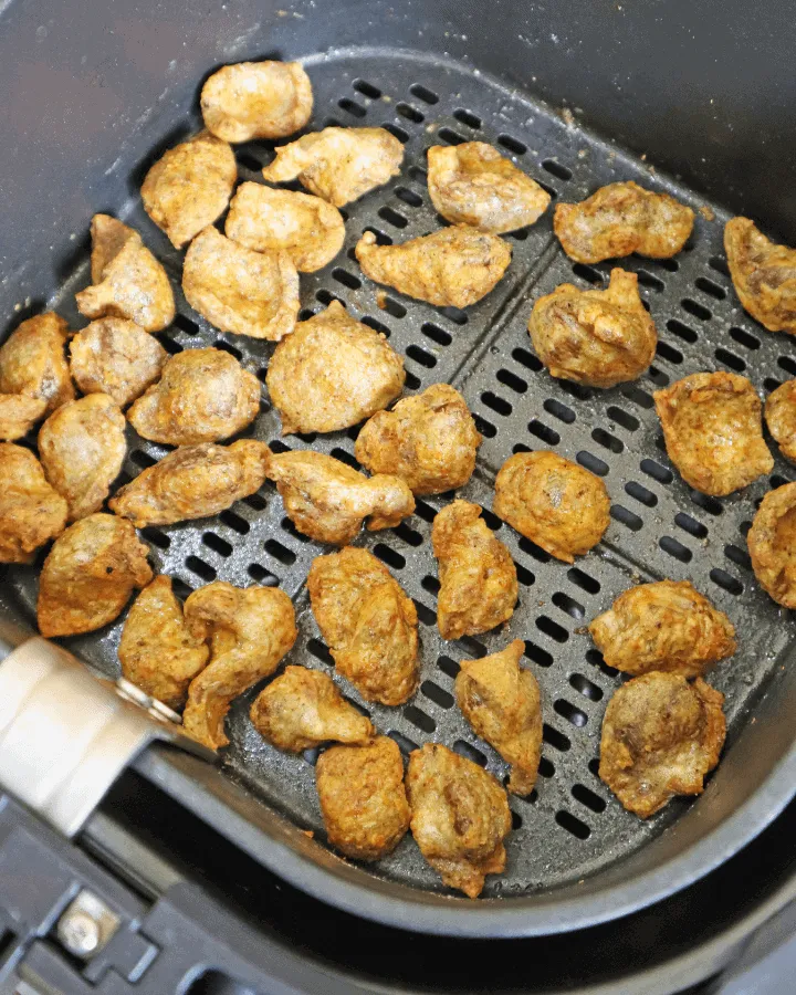 Chicken gizzards with oil and seasonings laid out on a counter