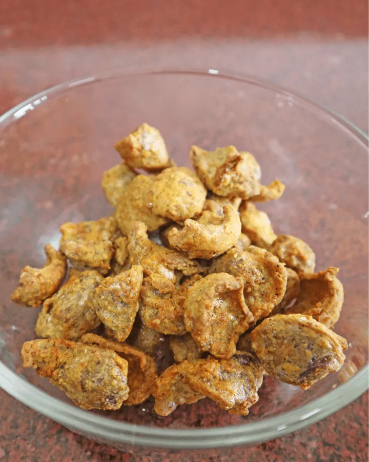 Seasoned gizzards spread in a single layer in the air fryer basket