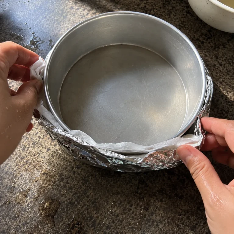 Wrapping a cake pan in foil and parchment paper