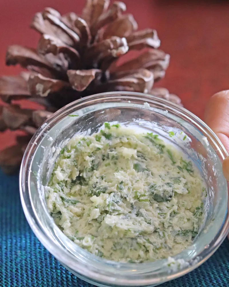 Finished garlic parsley butter mashed smooth in a small glass bowl