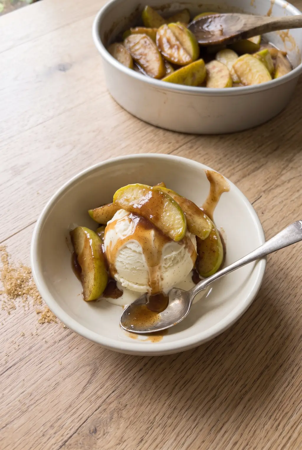 Warm air fryer cinnamon apples served close up with melting vanilla ice cream
