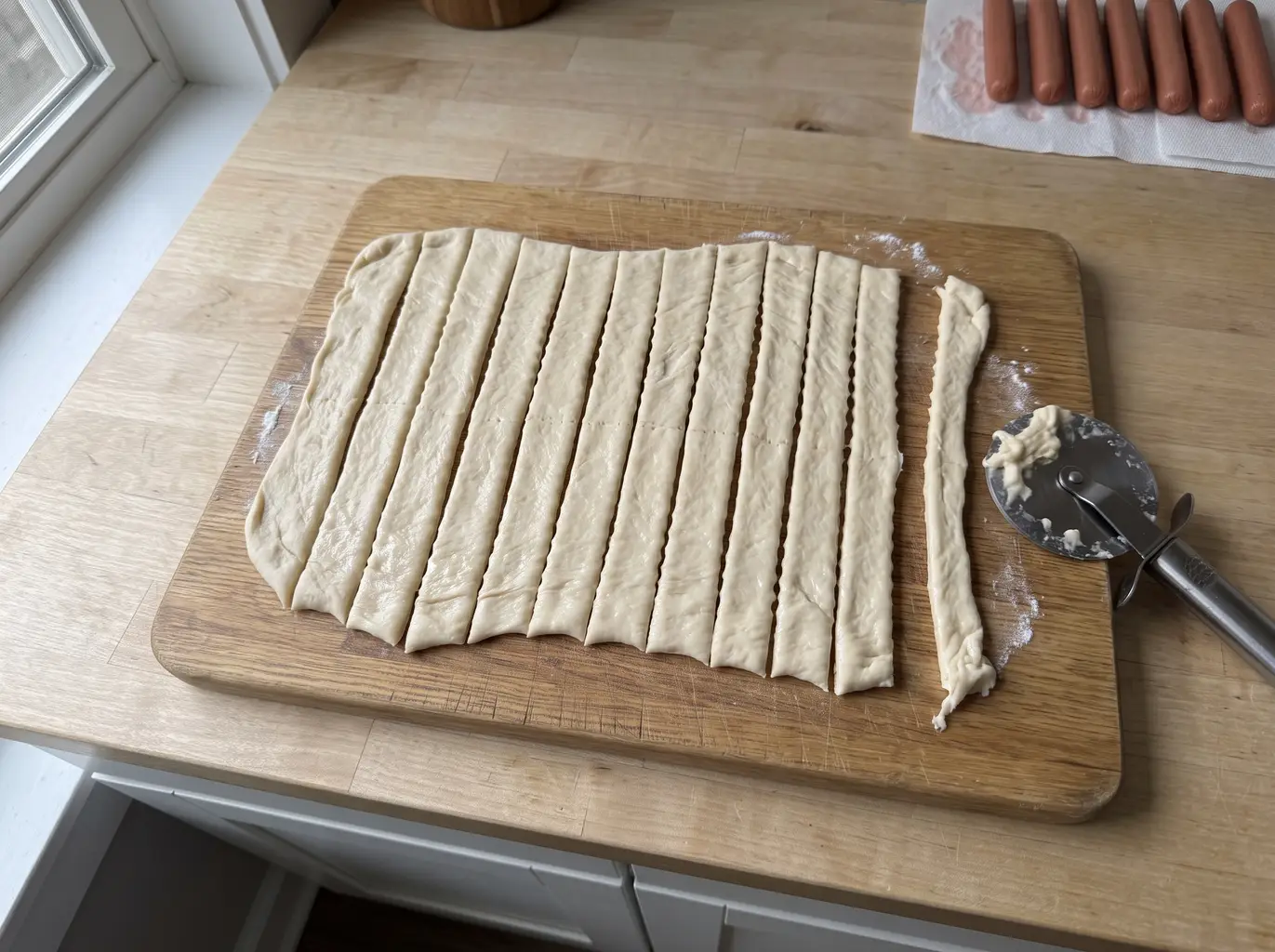 Crescent dough cut into ragged half-inch strips