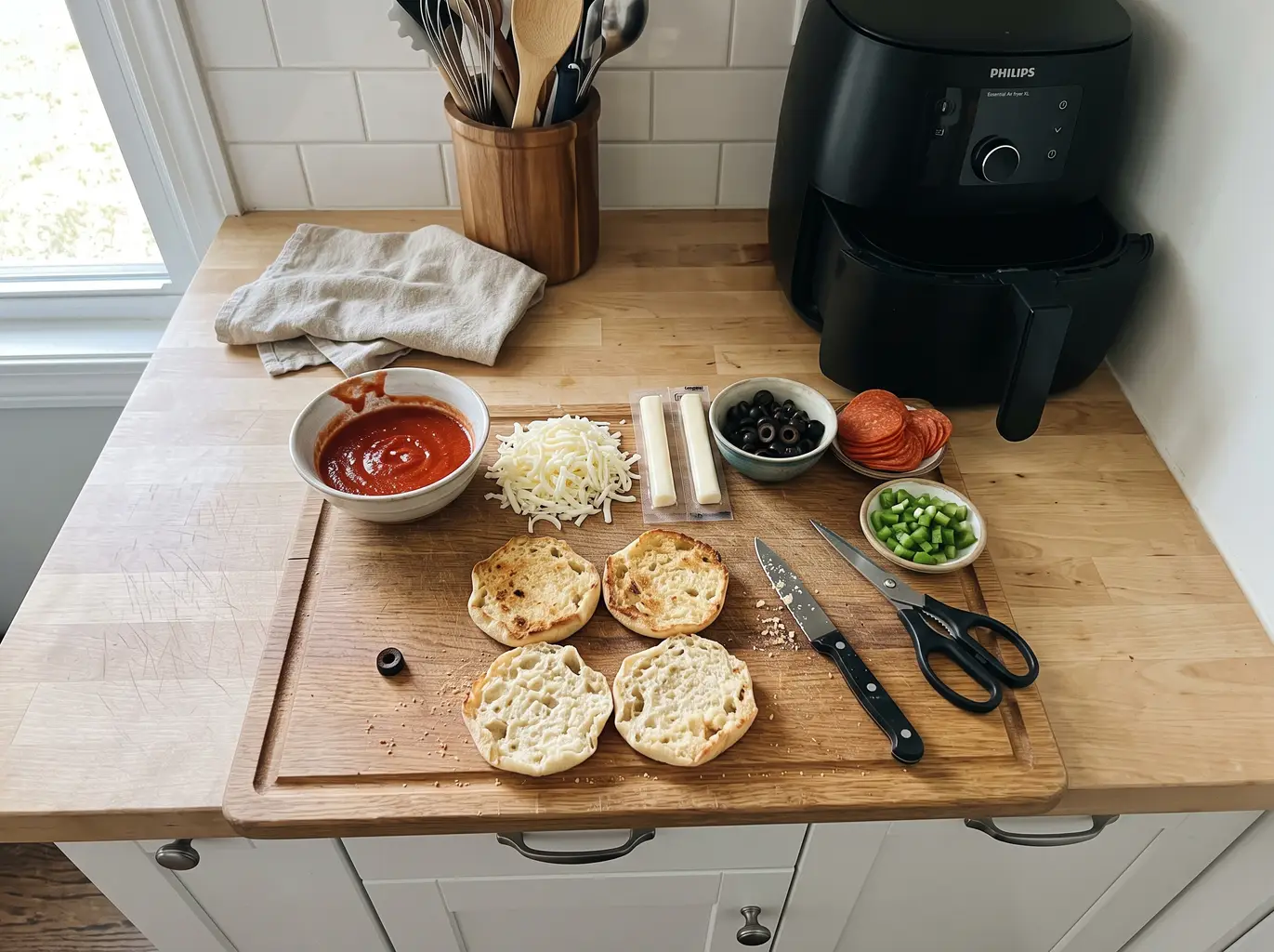 English muffins, sauce, mozzarella and toppings for Halloween mini pizzas