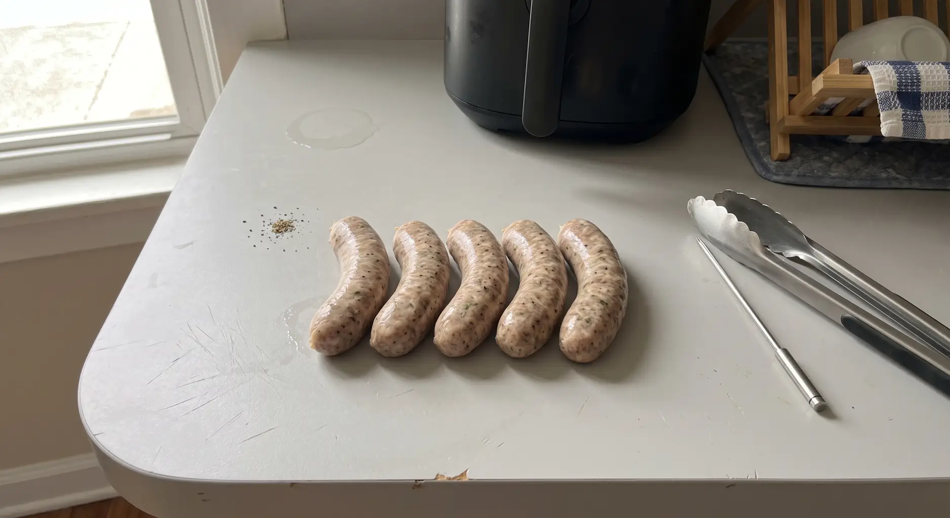 Ingredients for air fryer Italian sausage: fresh links, bell peppers, onion, olive oil and oregano