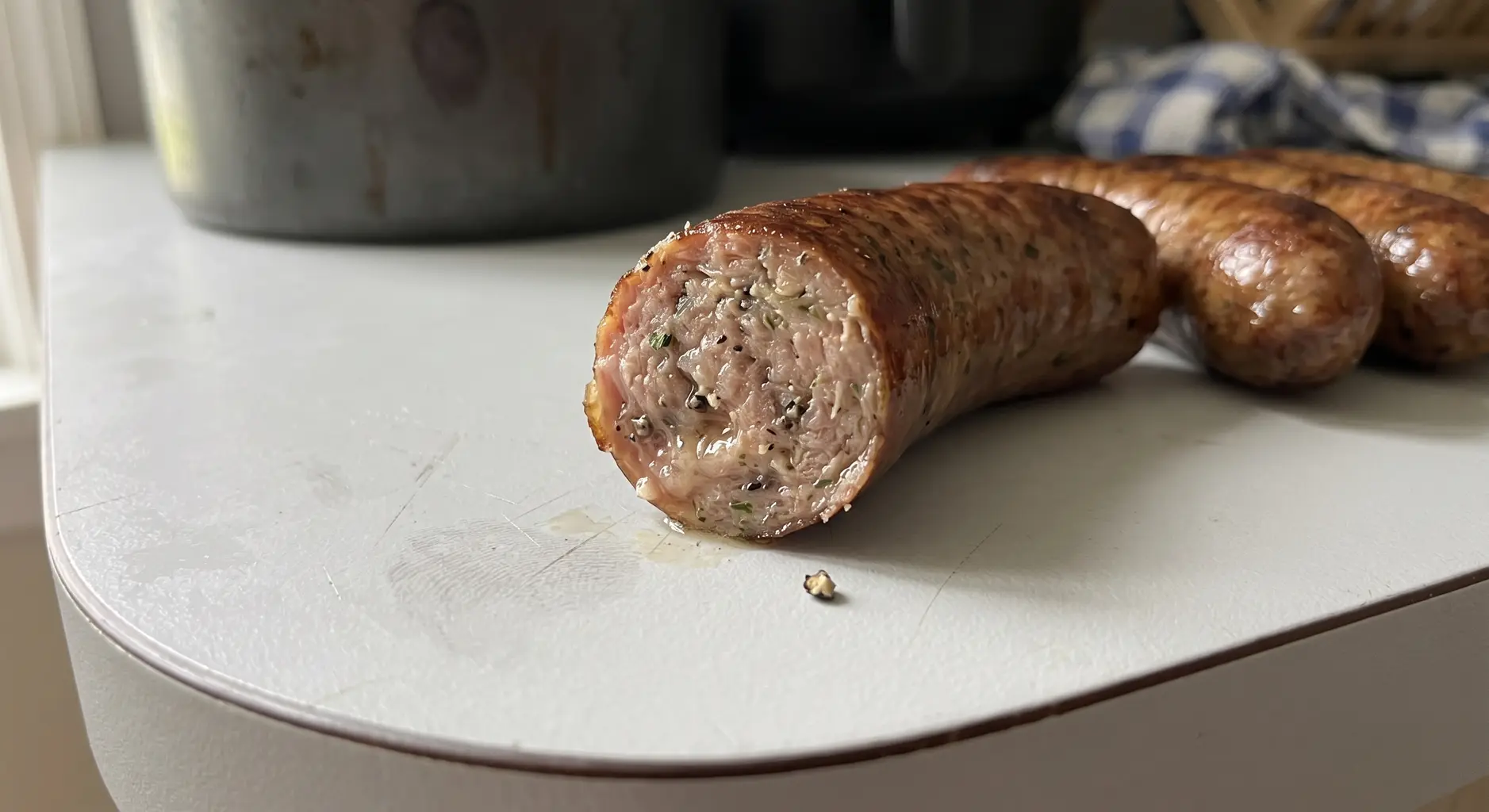 Close up of a sliced air fryer Italian sausage showing the juicy interior