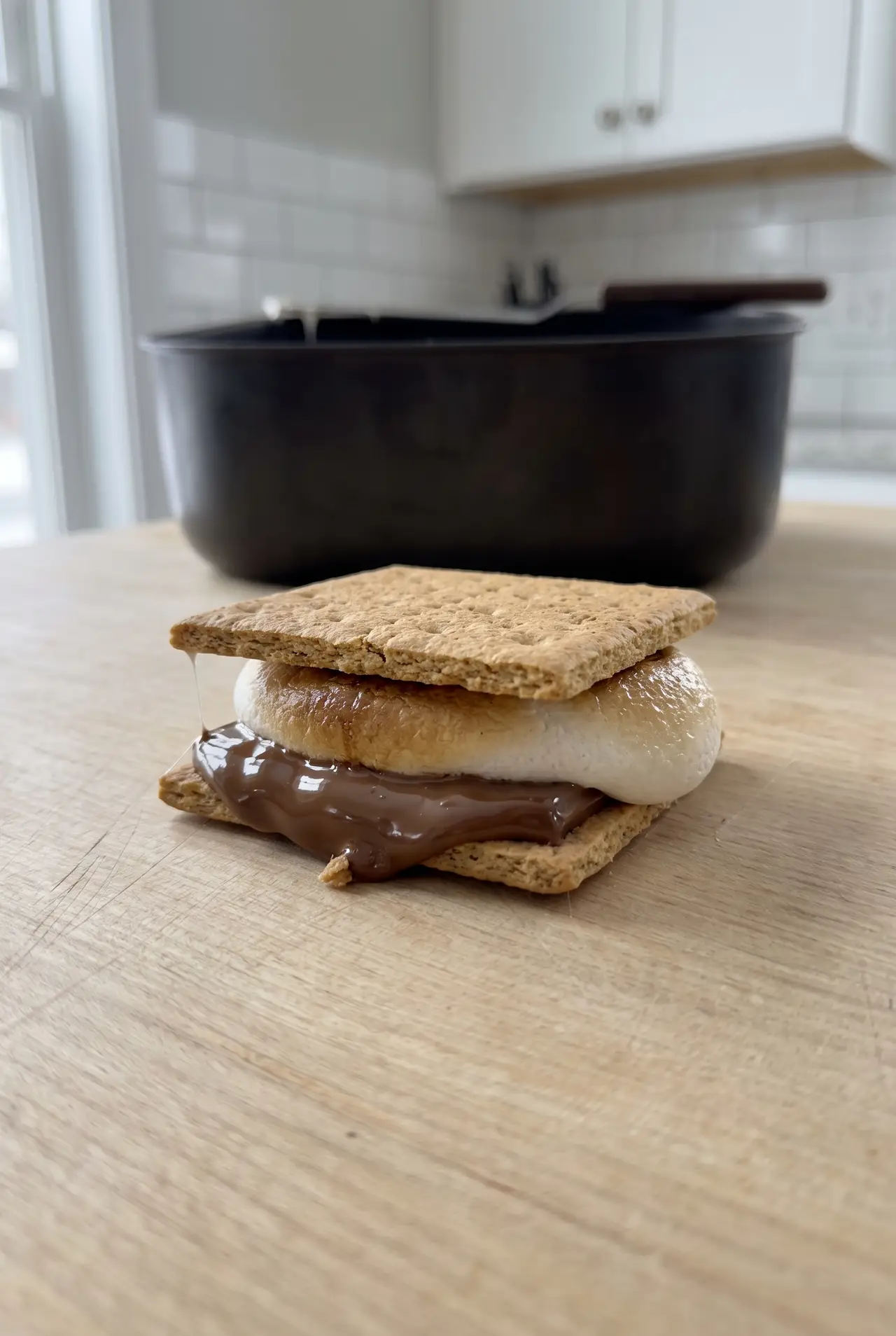 Close-up of a finished air fryer s'more, marshmallow deep golden and chocolate fully melted