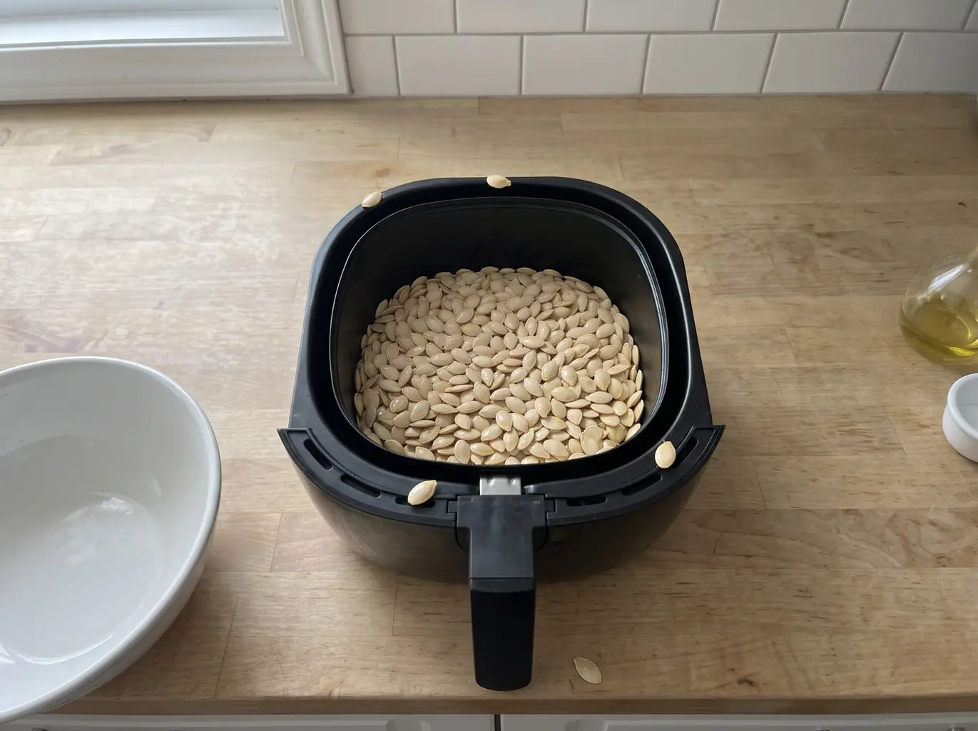 Pumpkin seeds in a single layer in the air fryer basket