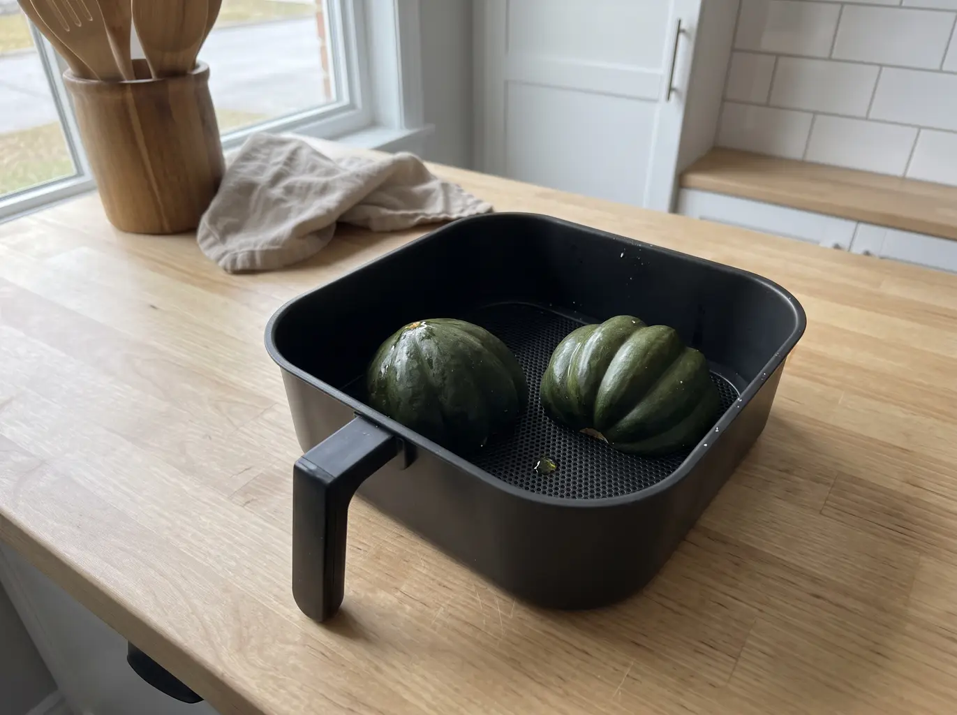 Acorn squash halves cut side down in the air fryer basket