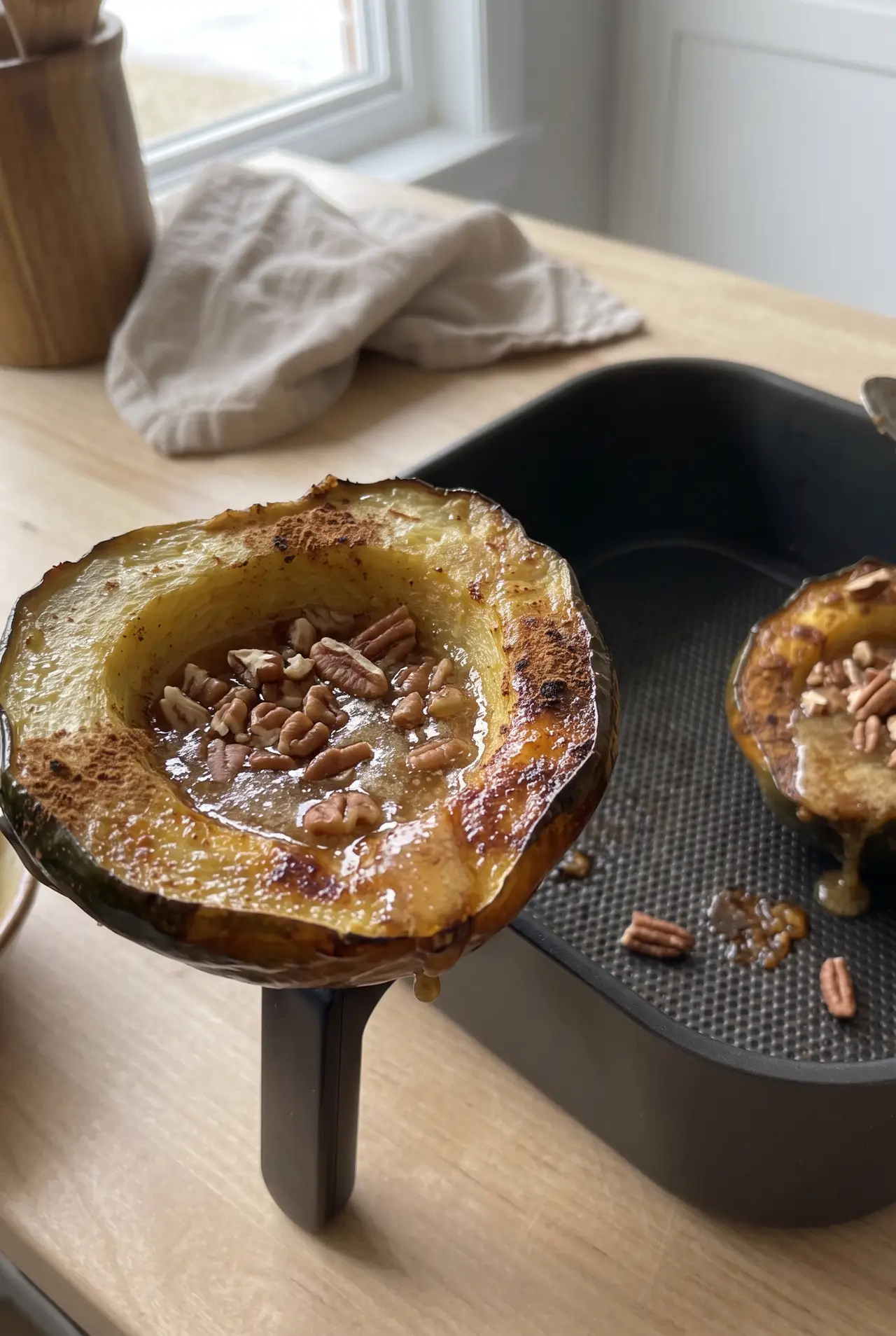 Close-up of air fryer acorn squash with maple butter