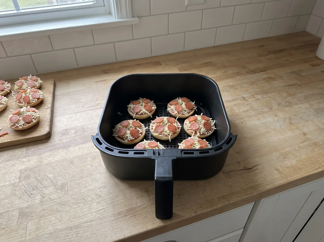 Frozen Bagel Bites in a single layer in the air fryer basket