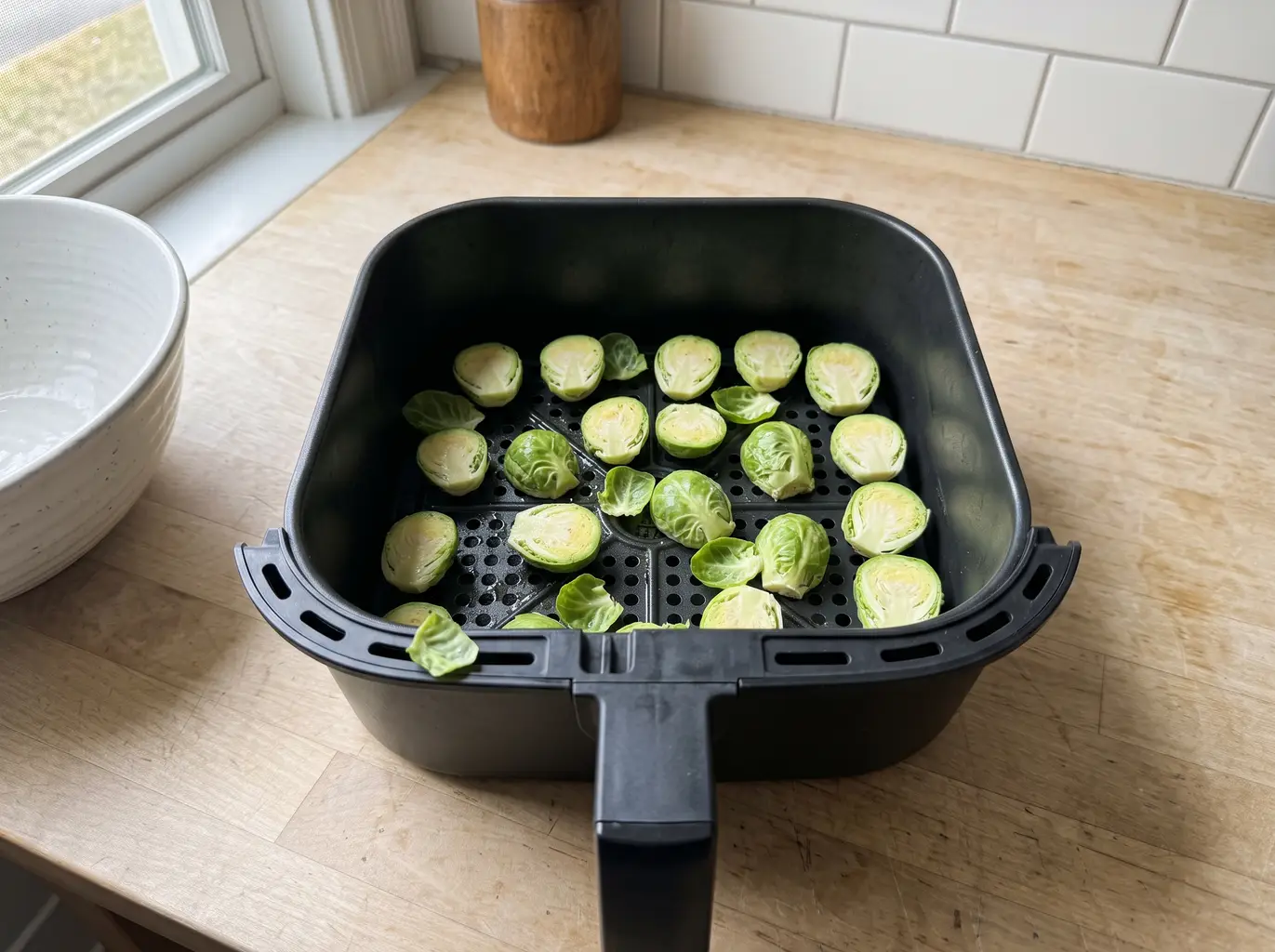 Brussels sprouts in a single layer in the air fryer basket