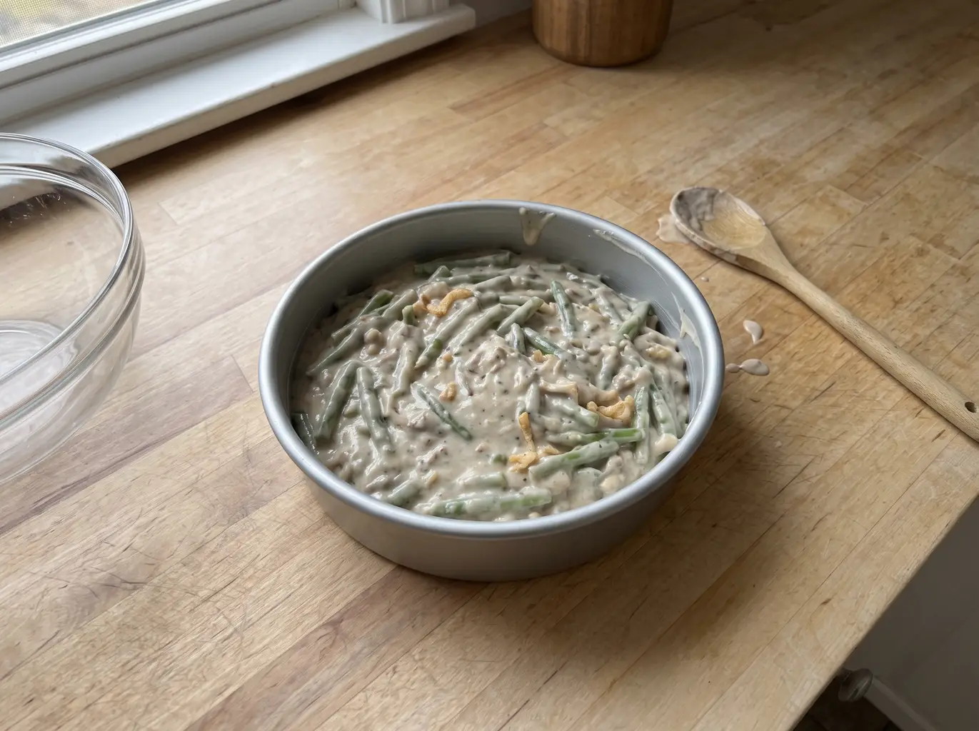 Green bean casserole spread into a baking pan