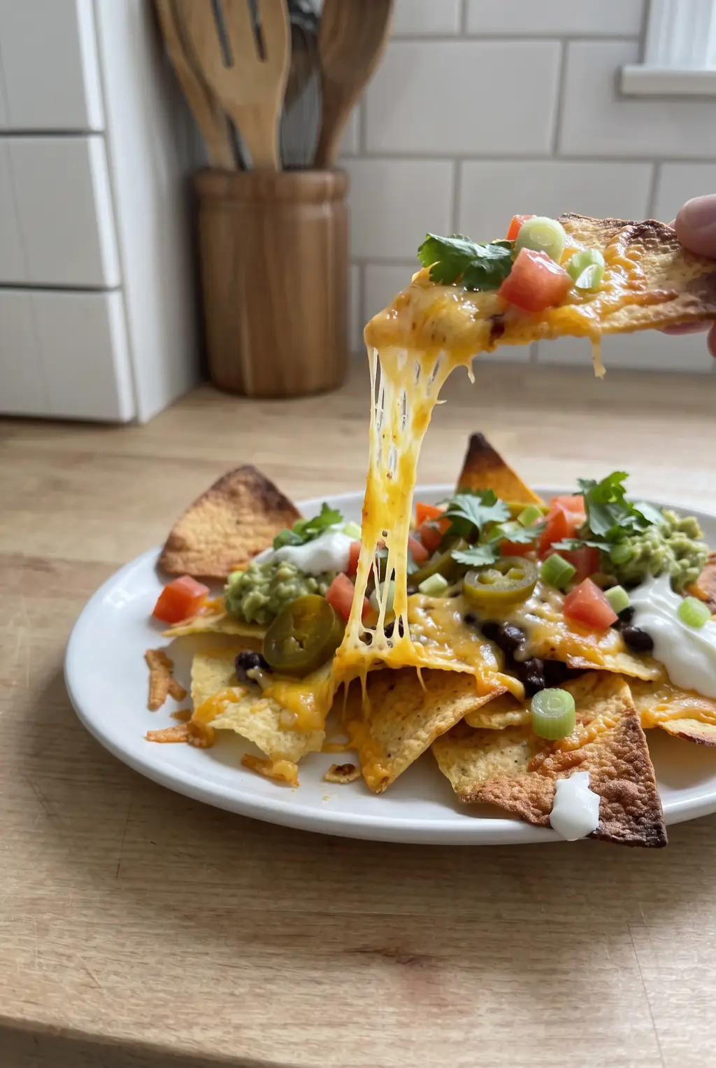 Melted nachos with a cheese pull