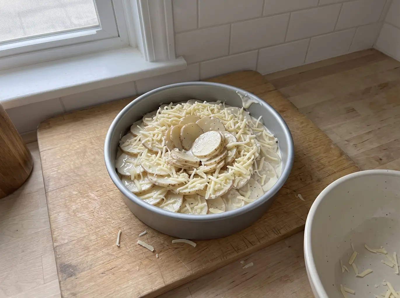 Potato slices layered into the baking pan