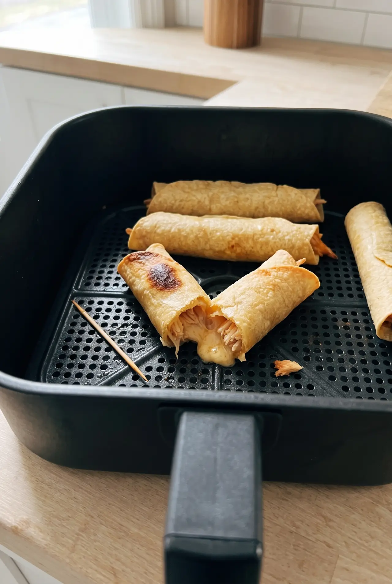 Close-up of a crispy air fryer taquito