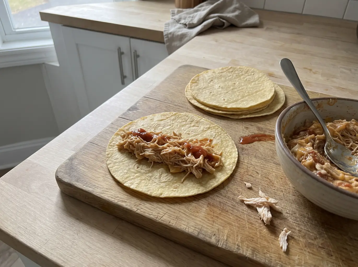 Taquito filling spread on a corn tortilla
